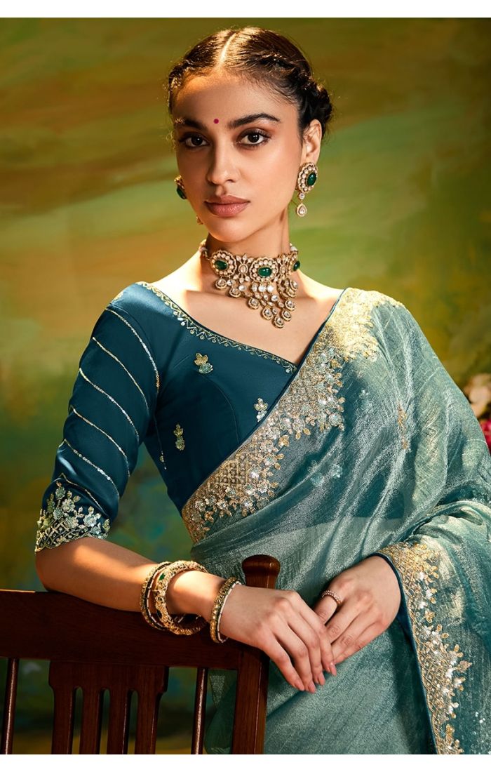 Side view of blue organza saree with lace border details