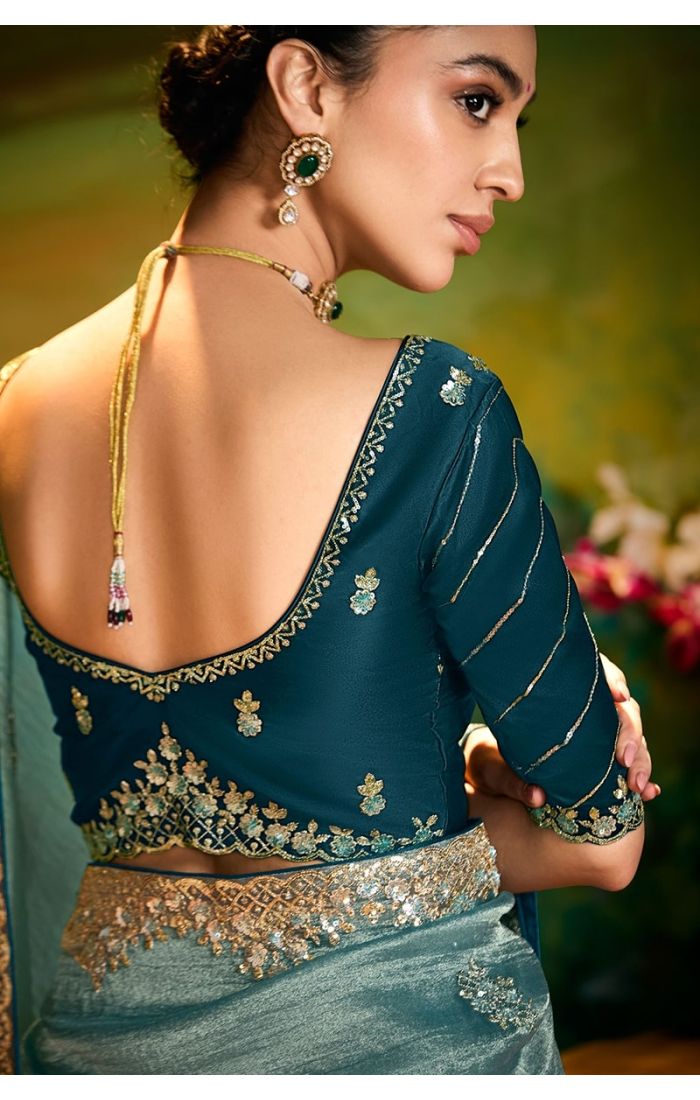  Back view showcasing blue raw silk blouse and embroidered saree drape
