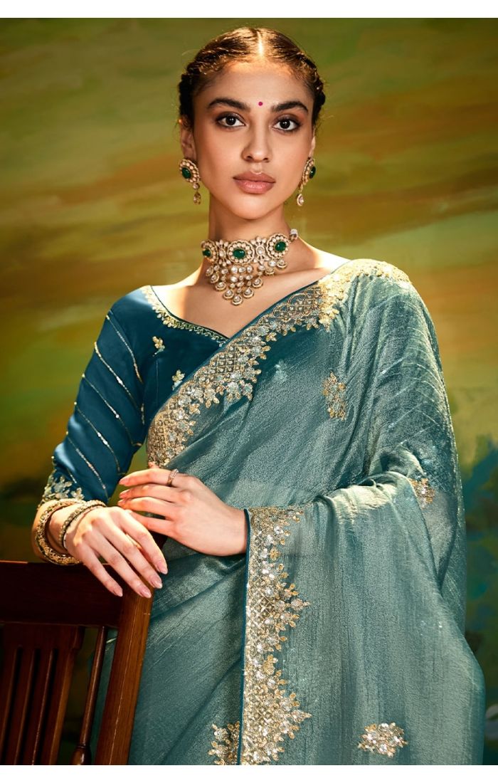  Close-up of blue organza saree with intricate zari and sequins embroidery