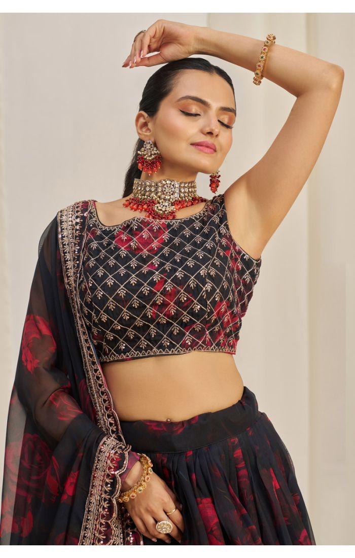 Close-up of embroidered black georgette round neck blouse with mirror work and red floral details – Navaratri party lehenga choli