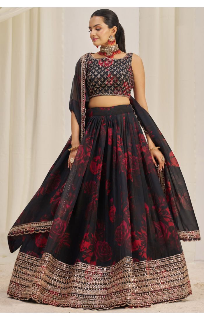 Designer black georgette lehenga choli featuring red floral print, golden embroidery and mirror work border – festive party outfit