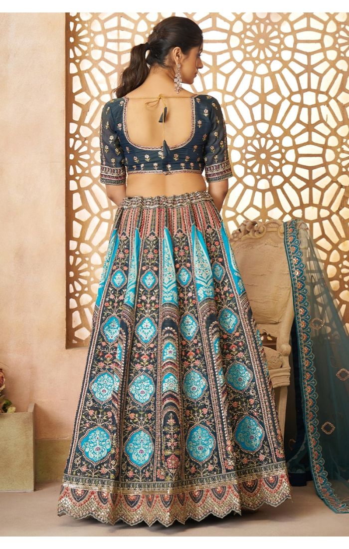 Back view of blue Banarasi lehenga with tie-up blouse and soft net dupatta drape