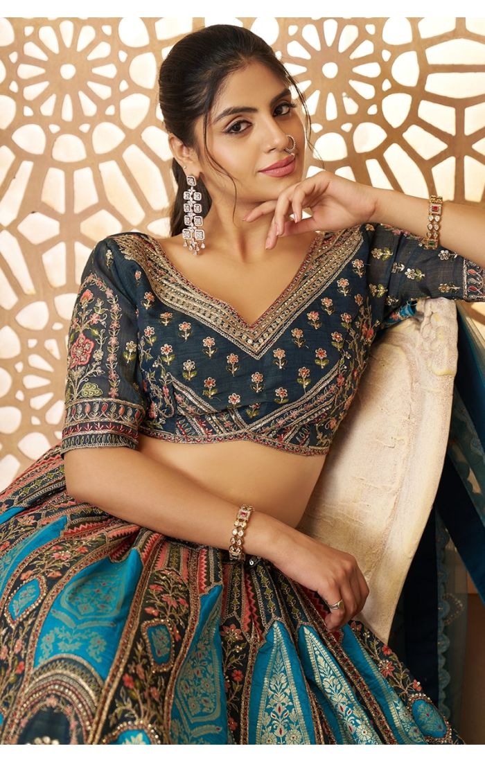 Close-up of bridal blouse in blue Aari embroidery with Banarasi motifs and V neckline
