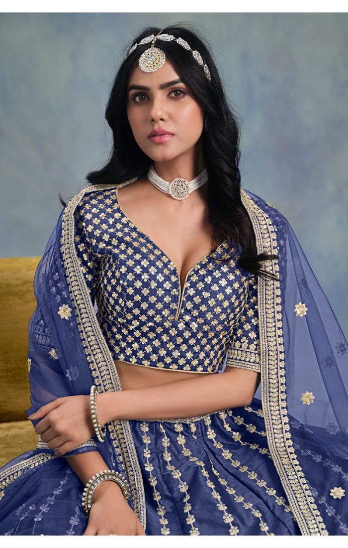 Sitting pose in Blue Designer Lehenga Choli with heavy embroidery and soft net dupatta