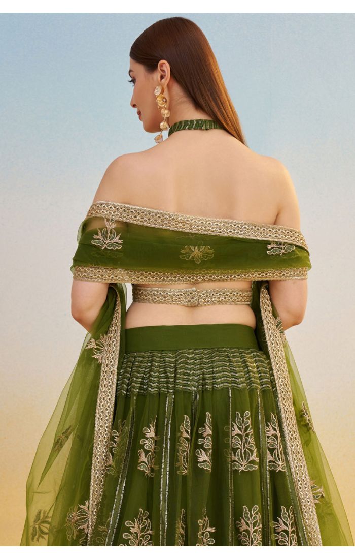 Flared skirt and border detailing of bottle green embroidered net lehenga with sequin motifs, modern festive and bridal fashion.