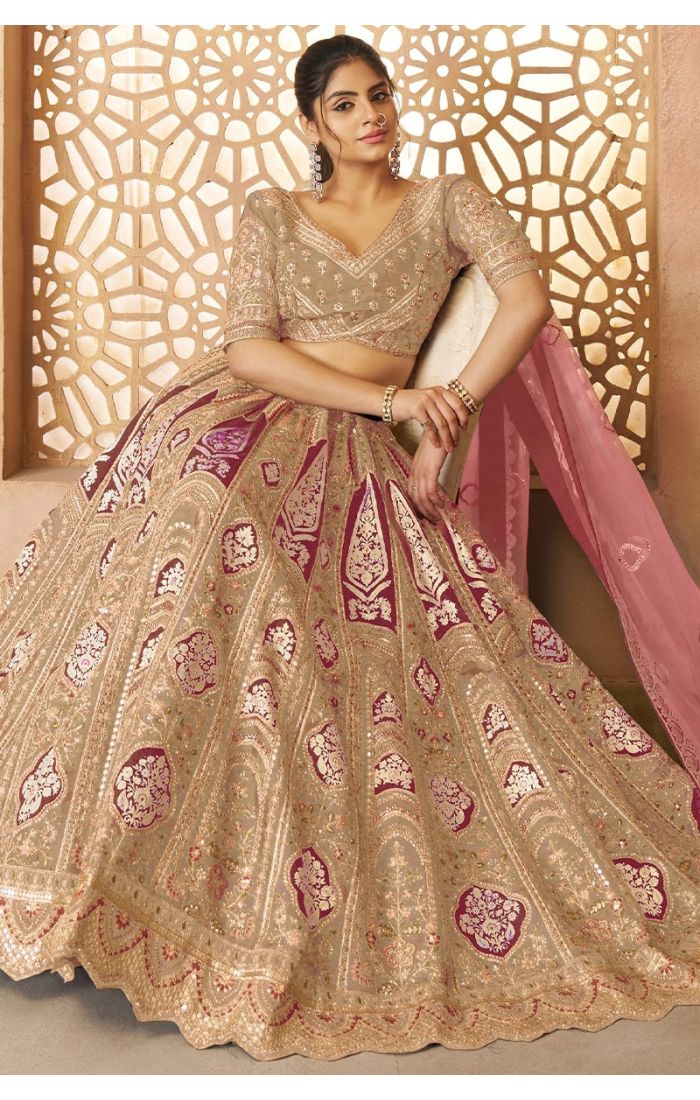 Luxury Indian bridal lehenga in champagne and pink with intricate aari and sequin work 
