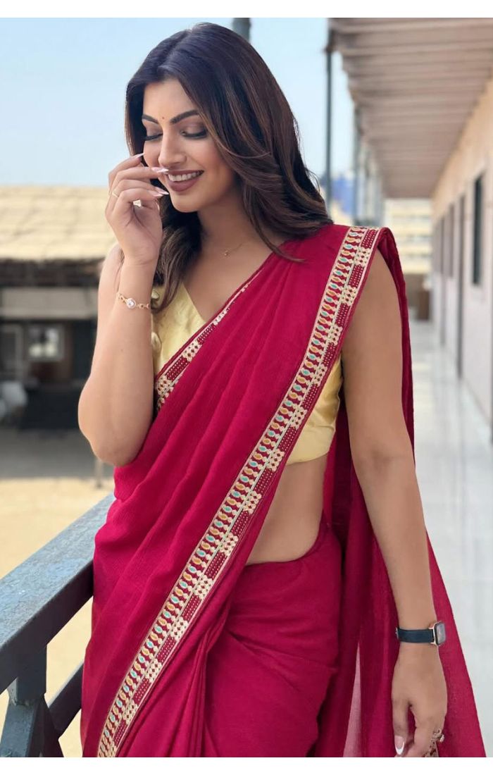 Woman wearing a maroon cotton blend saree with thread work and tassel border, paired with a sleeveless yellow blouse – perfect for casual and festive occasions.