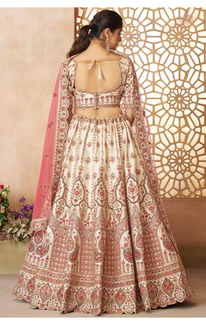 Back design of cream lehenga blouse with scoop neck and tie-up