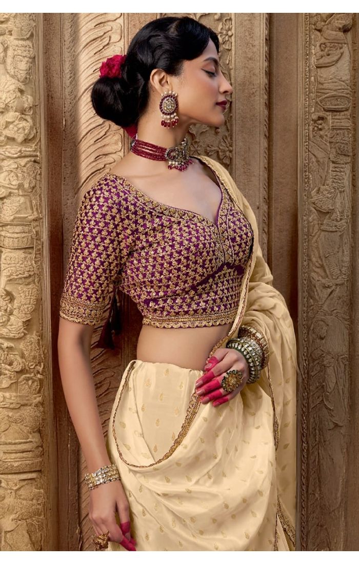 Model wearing cream saree for a wedding or engagement event