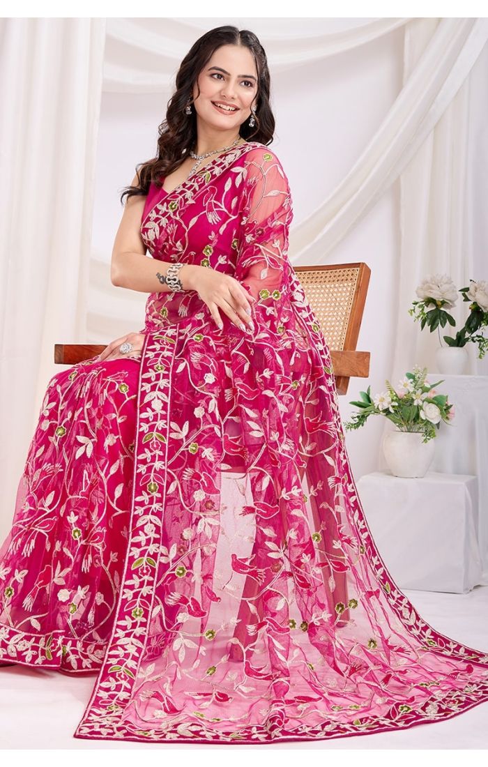 Sitting pose in dark pink embroidered net saree with Mono Banglori blouse