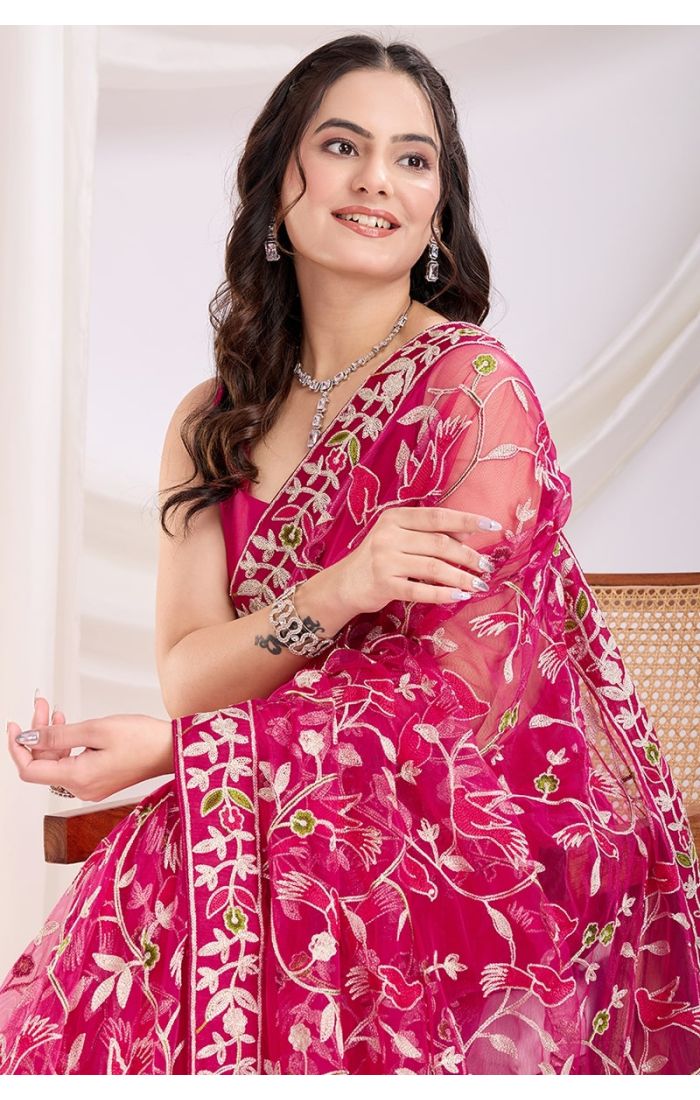 Close-up of designer embroidery on dark pink soft net saree with intricate details