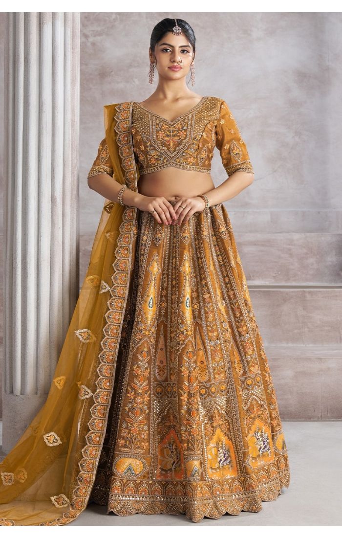  Front view of mustard bridal lehenga with embroidered blouse and flowy net dupatta – Appelle Fashion