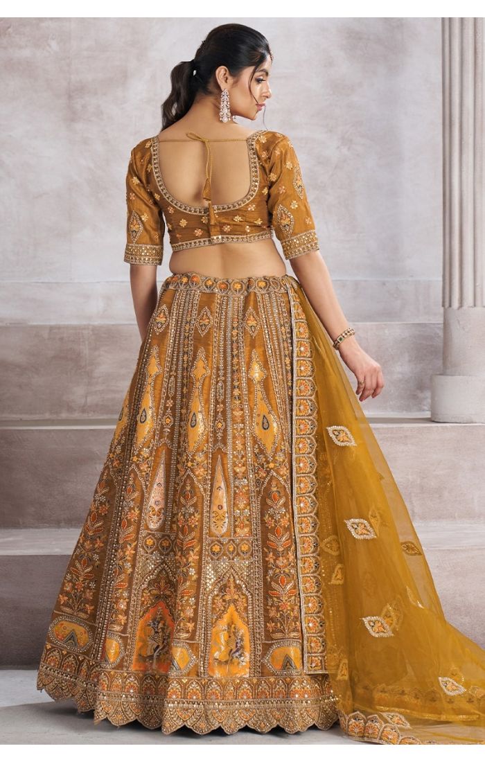 Back view of earthy mustard bridal lehenga with intricate patchwork and aari embroidery – Appelle Fashion