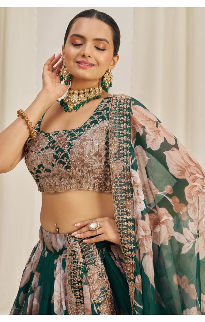 Close-up of embroidered blouse in emerald green floral net lehenga choli.