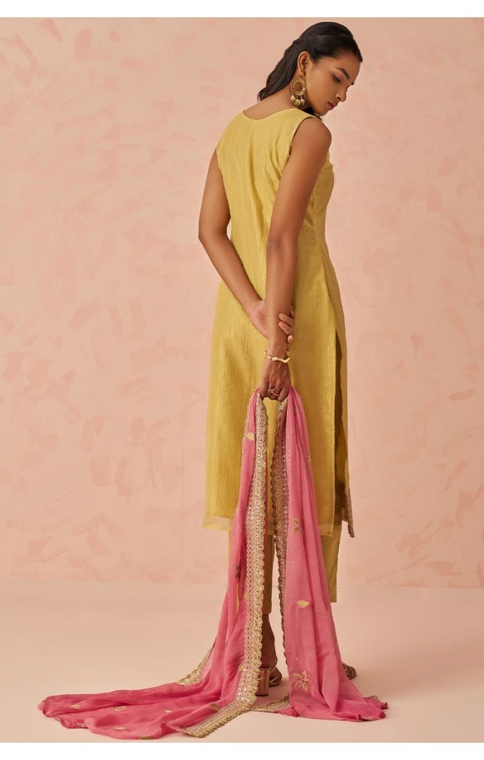 Back view of golden Fancy Crush Silk salwar kameez paired with pink chiffon dupatta, minimalistic chic look — designer ethnic wear.