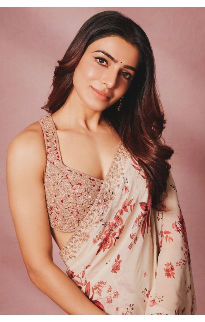 Close-up of model in floral print saree and detailed blouse on pink backdrop