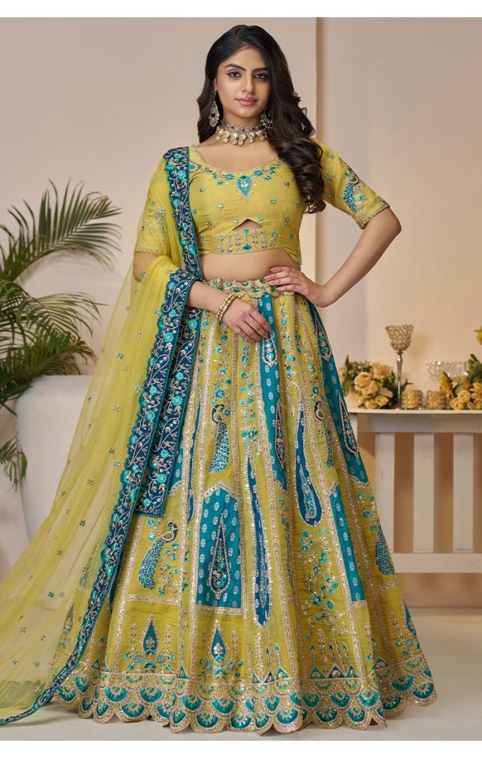 Front view of golden soft net embroidered lehenga choli with peacock motifs for sangeet