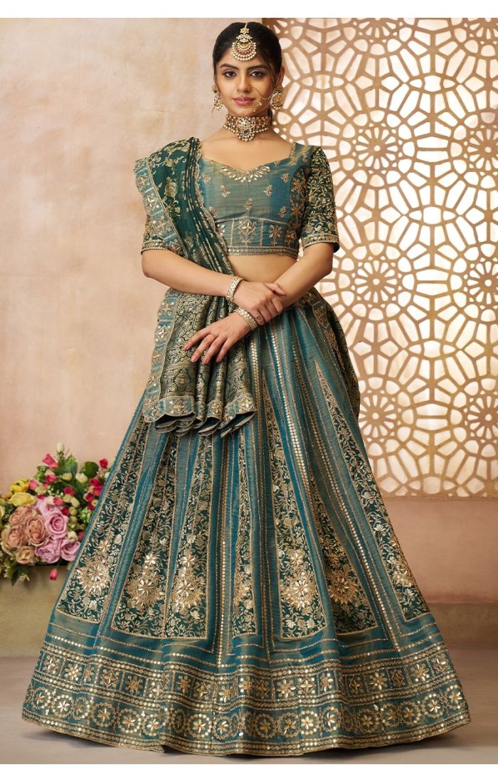 Full front view of green tissue bridal lehenga with intricate golden zari work and Banarasi panels.
