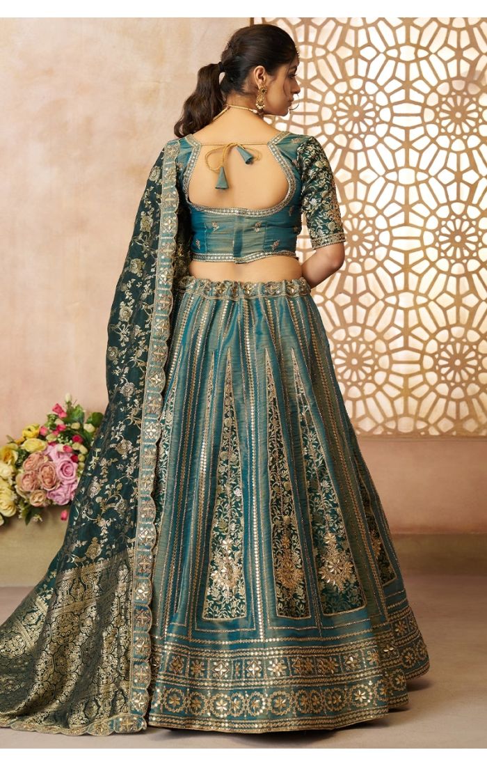 Back design of regal green bridal lehenga with Banarasi dupatta and zari embroidery – Appelle Fashion USA.