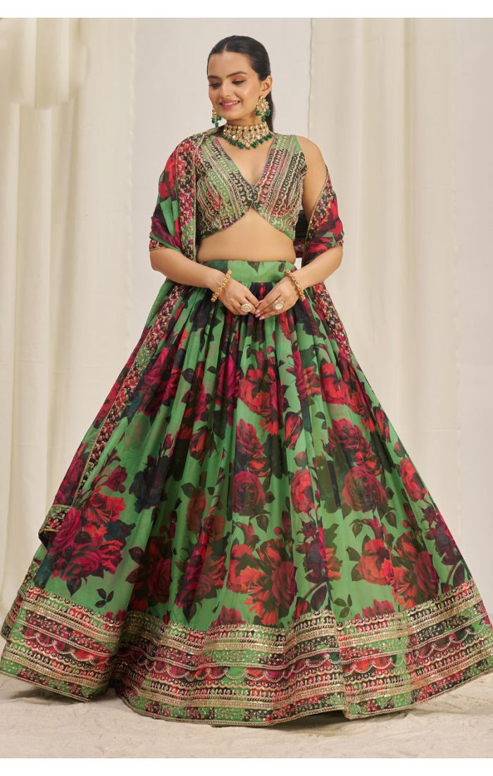 Twirling front view of green floral lehenga showcasing flare and border design