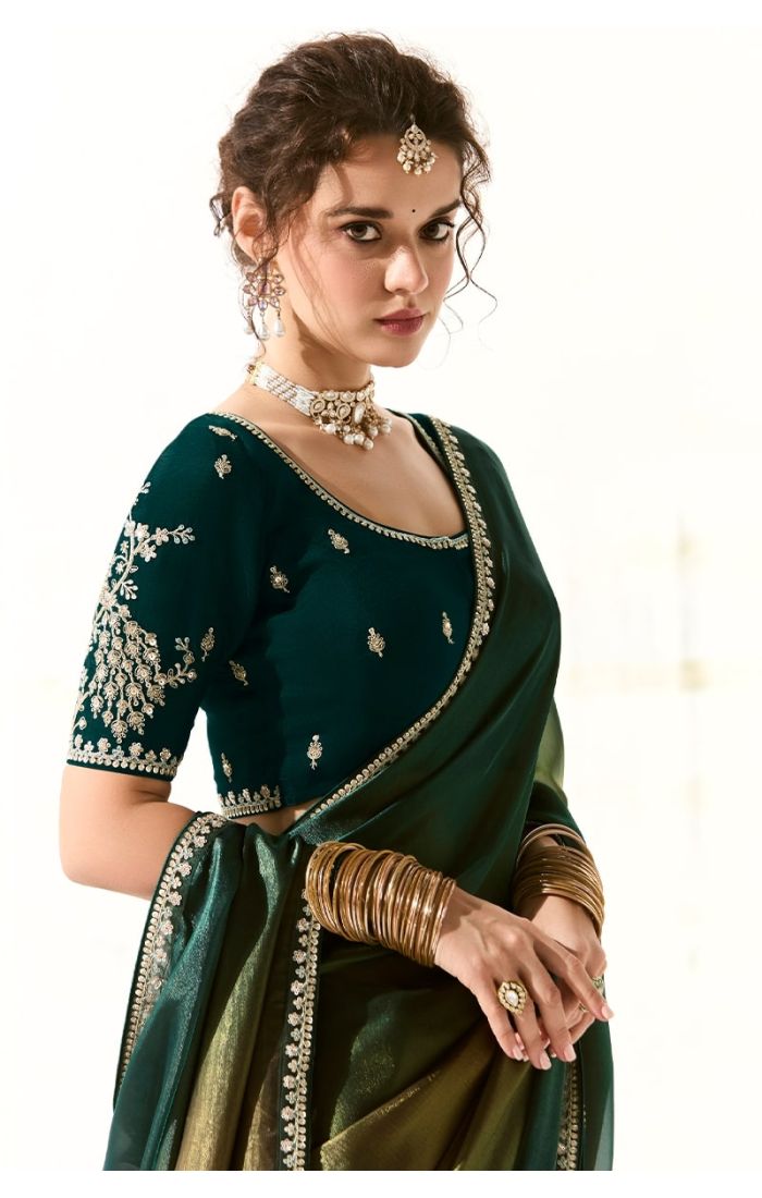 Close-up of zari and sequin embroidered blouse in pure silk paired with organza saree – elegant festive Indian attire.