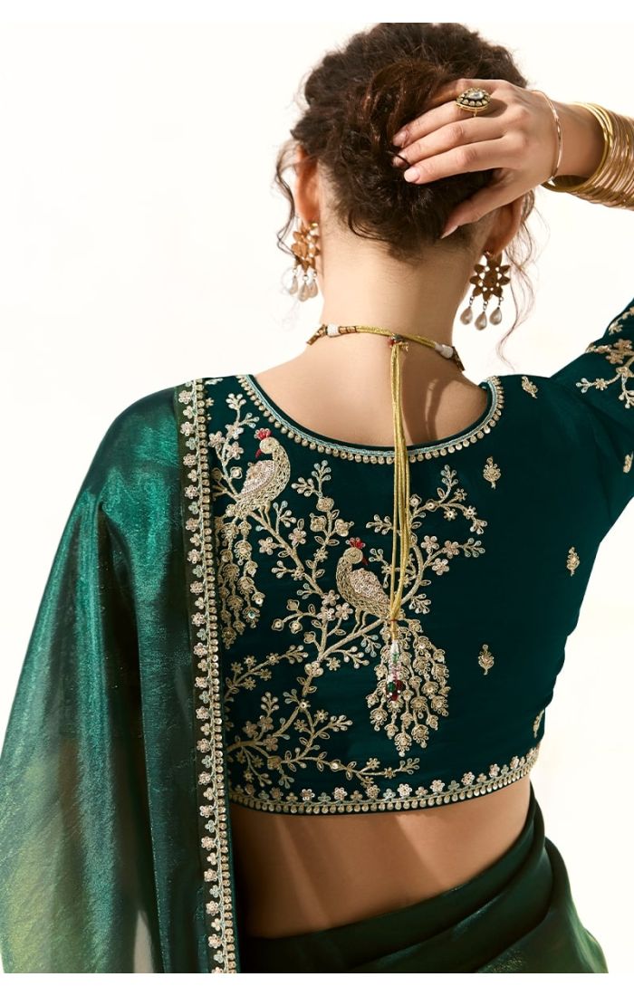 Back view of blue silk blouse featuring intricate golden peacock and floral embroidery – unstitched designer blouse.