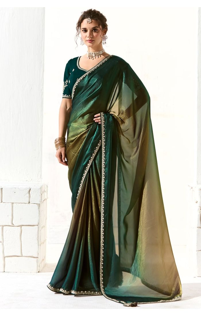Full view of green organza tissue silk saree with zari and sequin work, worn with embroidered blue silk blouse – festive ethnic wear.