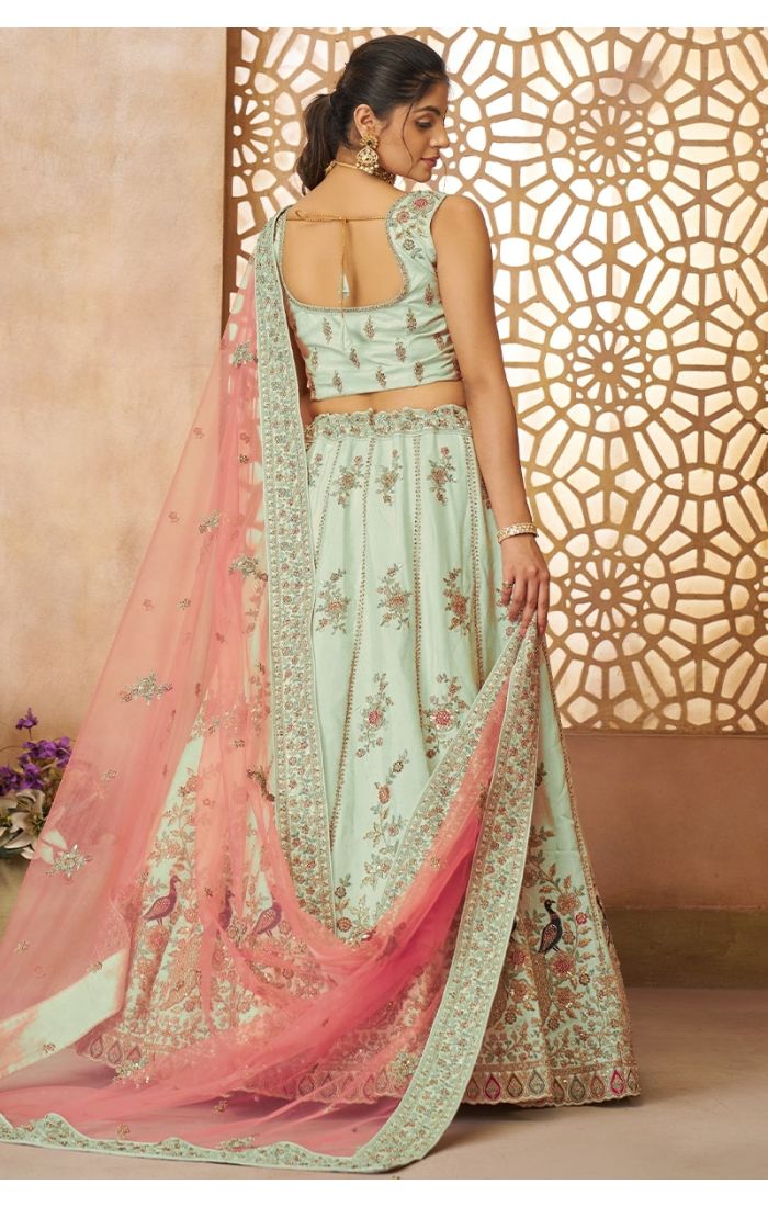 Model showing back of green zari silk lehenga choli with embroidered pink net dupatta – ethnic wedding outfit USA