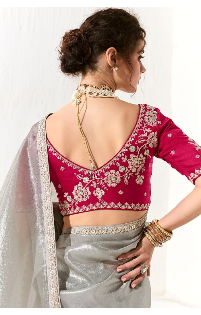  Back design of magenta embroidered blouse with deep neckline and grey tissue silk saree