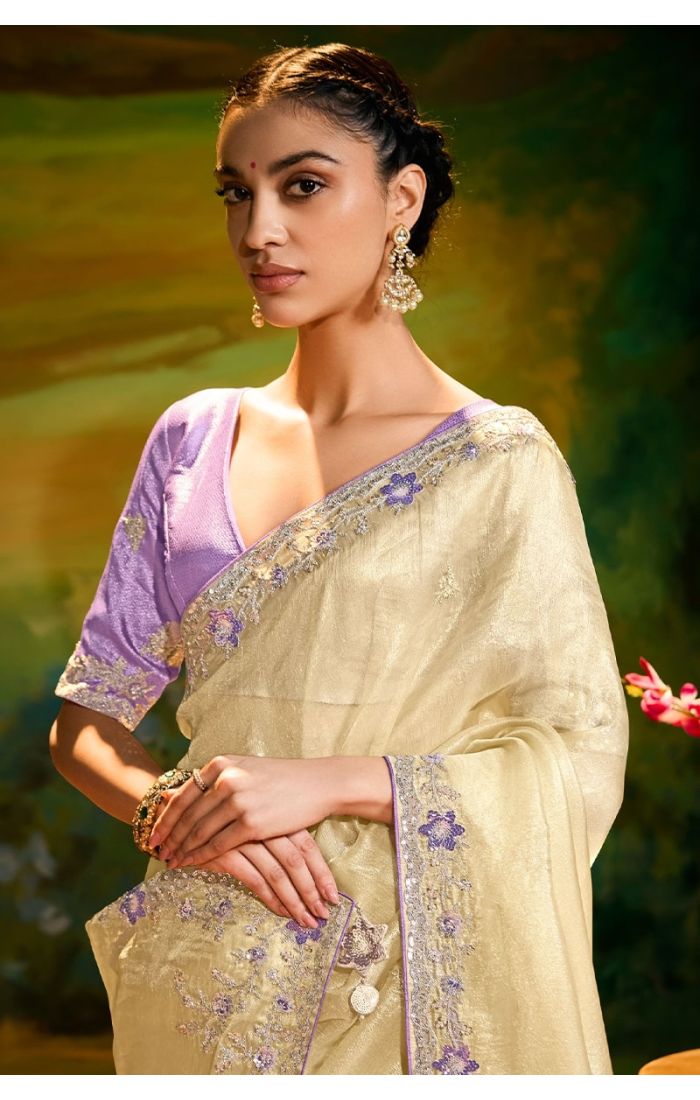 Close-up of zari and resham embroidery on cream organza saree with lace border