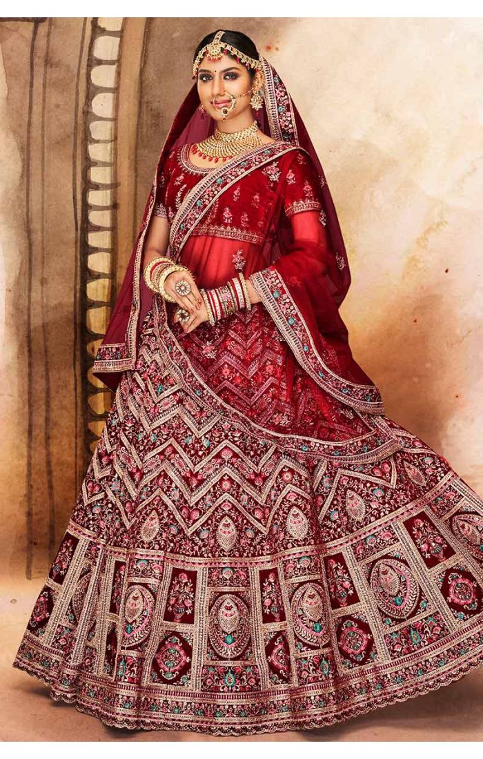 Flared skirt and intricate border of maroon velvet lehenga with heavy embroidery, perfect luxury bridal ensemble.
