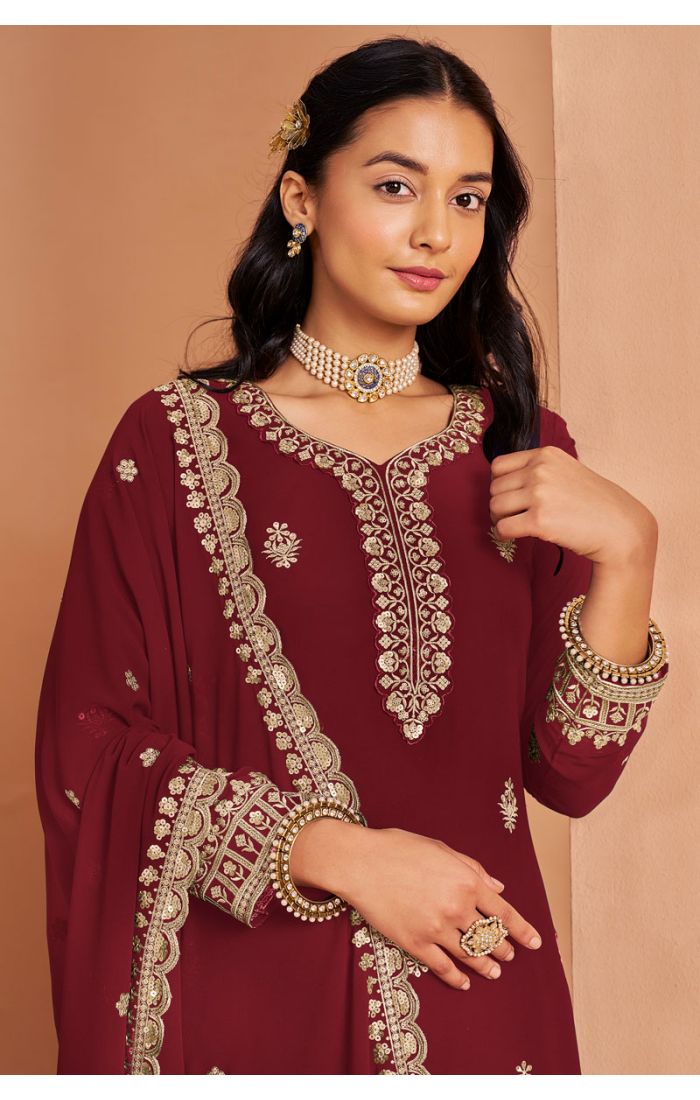Close-up of maroon georgette salwar suit neckline and sleeve embroidery