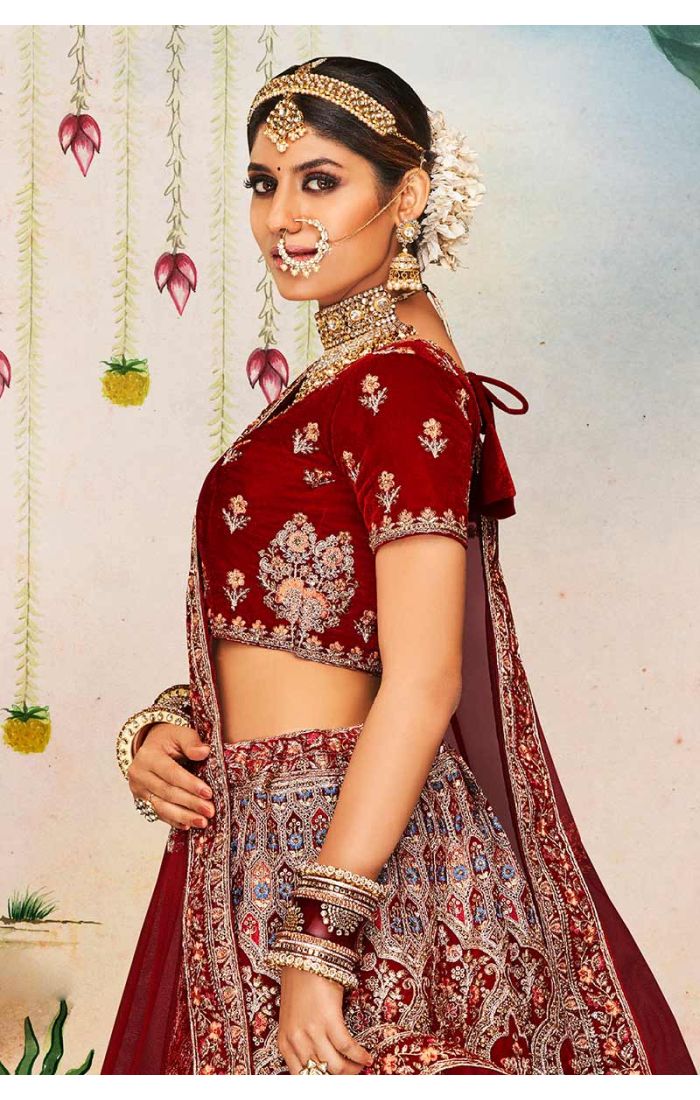Side close-up of maroon velvet bridal blouse with scoop neck and heavy embroidery, luxury Indian bridal couture by Appelle Fashion.
