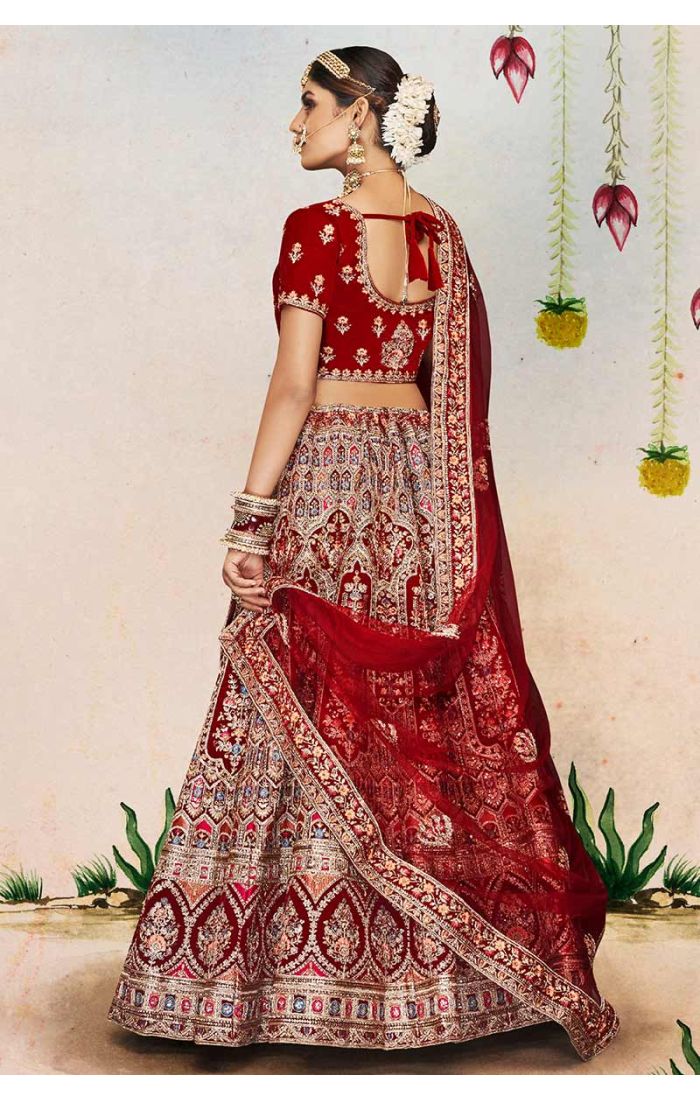Flared skirt and ornate border of maroon velvet bridal lehenga with exquisite embroidery, statement wedding couture.
