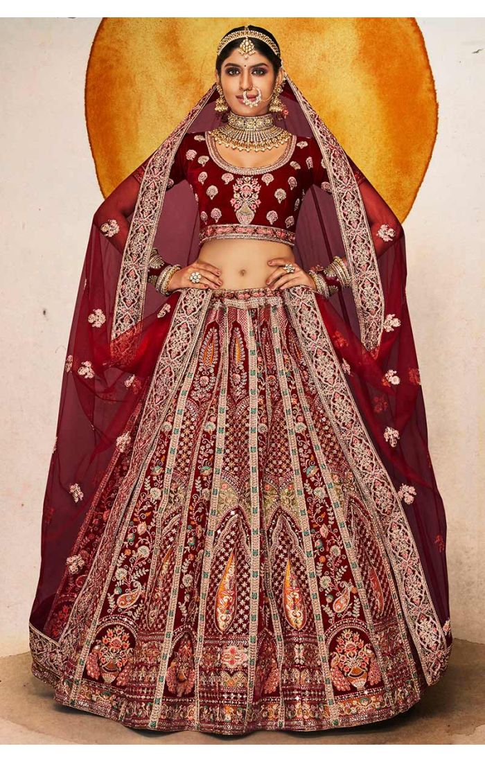 Detailed shot of maroon bridal blouse with U neckline and embroidered dupatta, premium wedding couture.