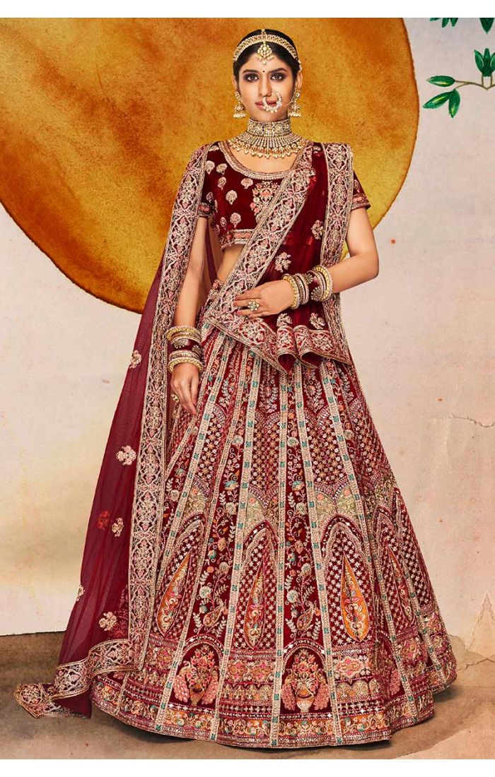 Maroon velvet bridal lehenga with U neck blouse and heavy embroidery, royal Indian wedding couture by Appelle Fashion.