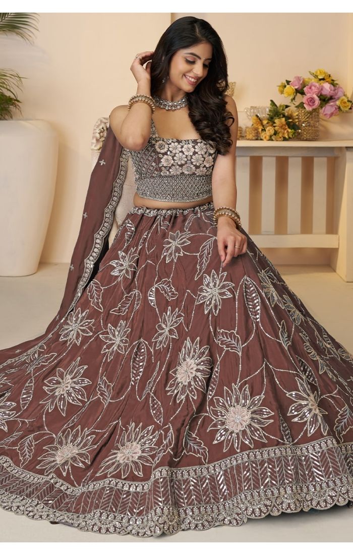  Sitting pose showcasing mauve floral lehenga with sequin embroidery