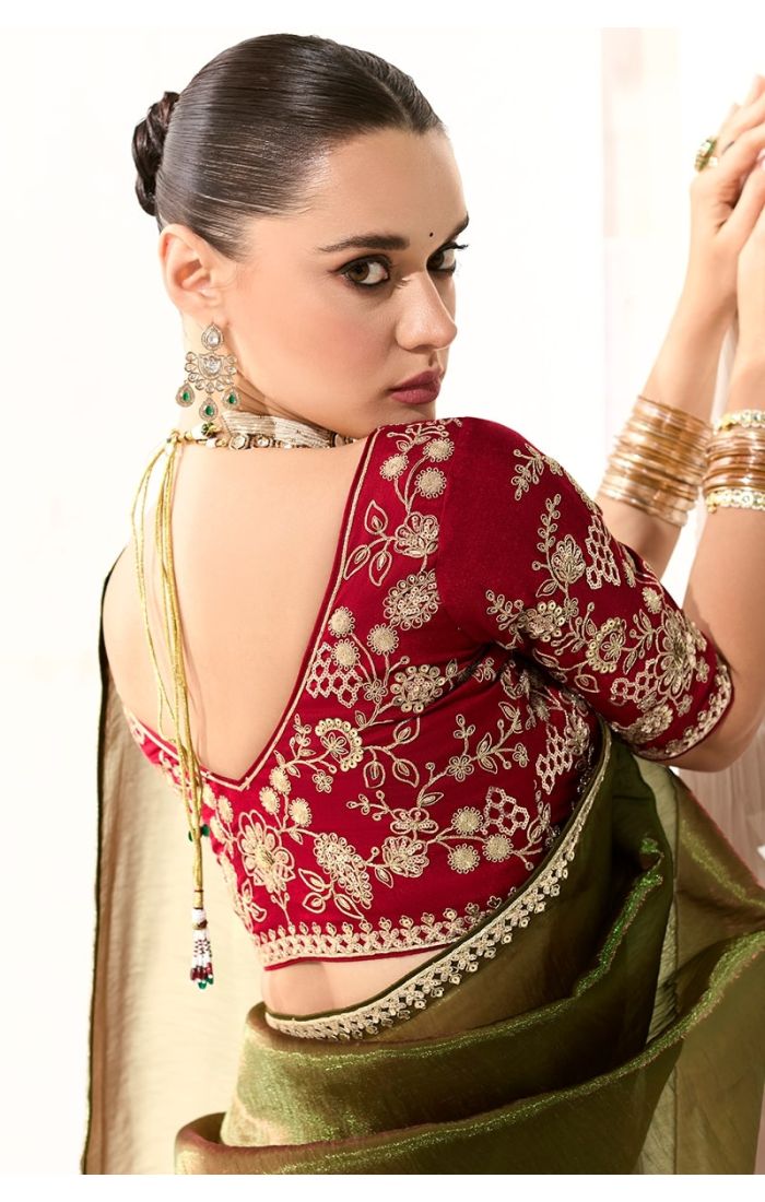 Back design of the red embroidered blouse with deep-cut neckline and tie detail.