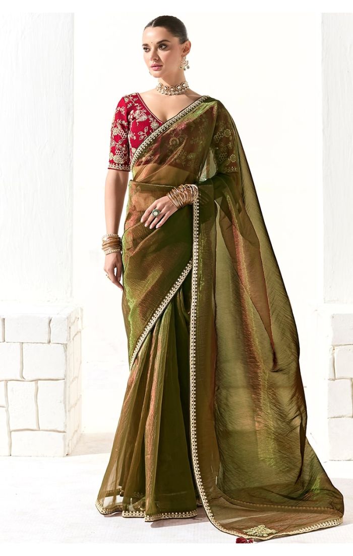 Model wearing mehndi green organza silk saree with red embroidered blouse – full-length front pose.