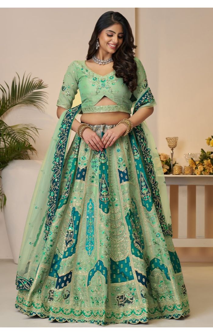 Front view of Rajsi Haathi bridal lehenga worn by model with royal embroidery and teal dupatta.