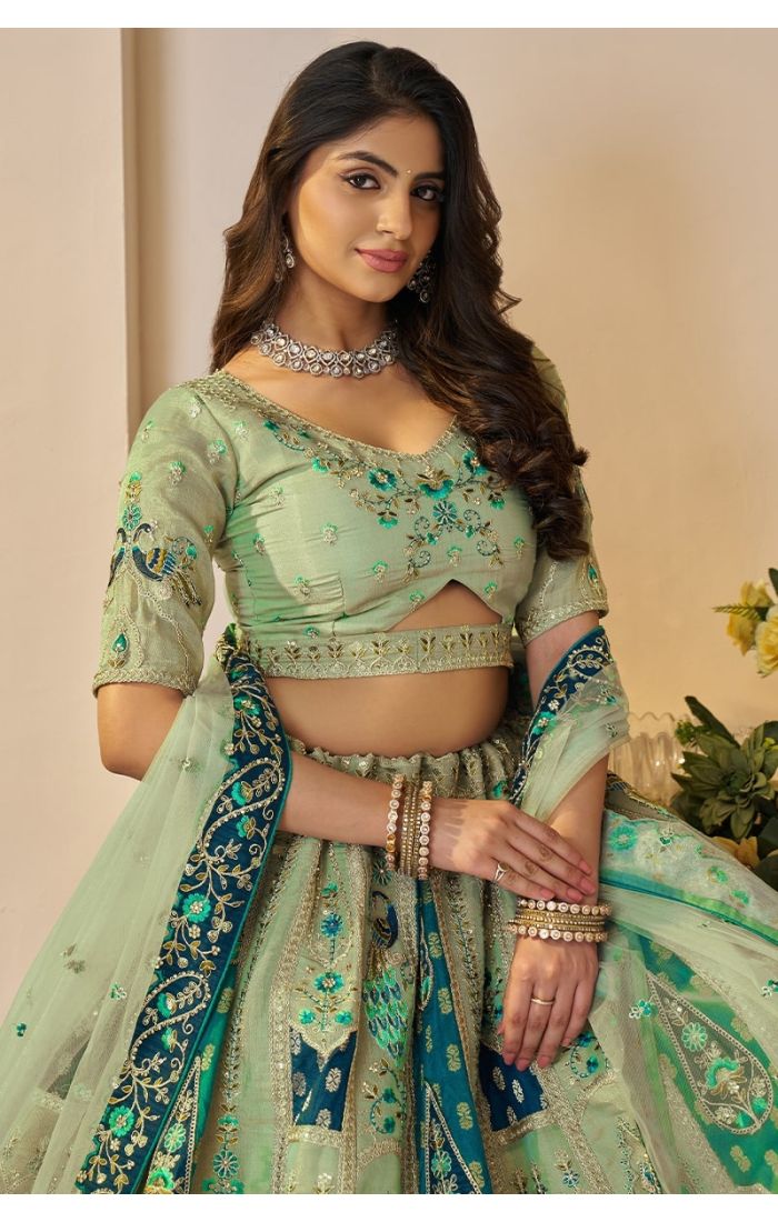 Close-up of bride in mint green blouse and embroidered lehenga from Rajsi Haathi Collection.