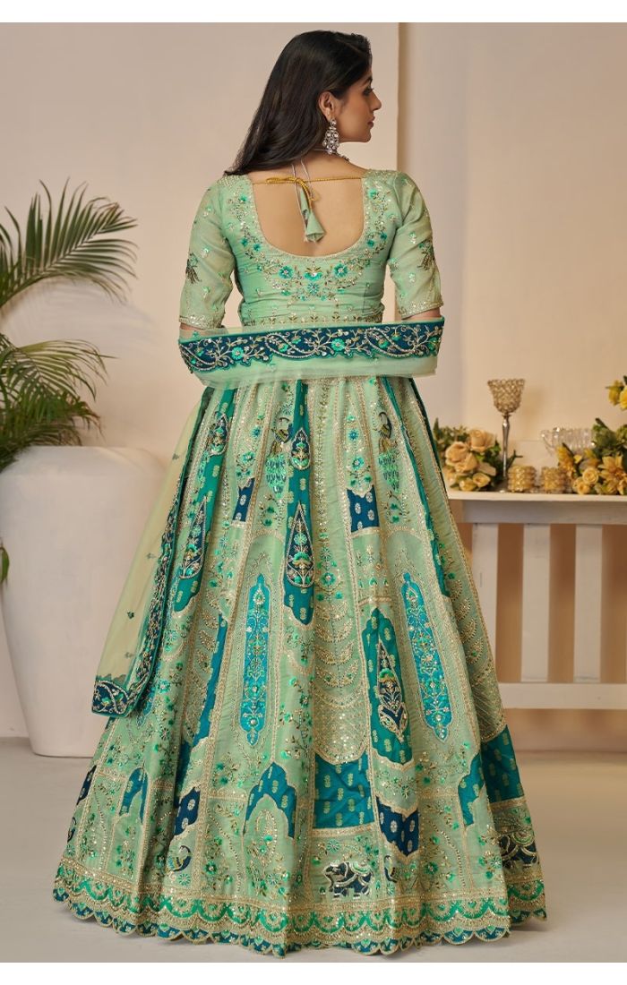  Back view of mint green bridal lehenga with peacock embroidery and elephant motifs in soft net.