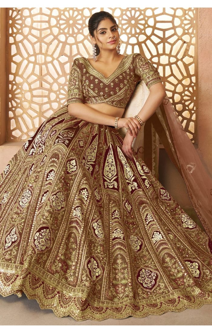 Bride sitting in mocha aari embroidered lehenga with floral motifs