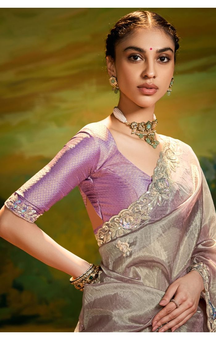 Close-up of grey organza saree with zari and sequins embroidery details