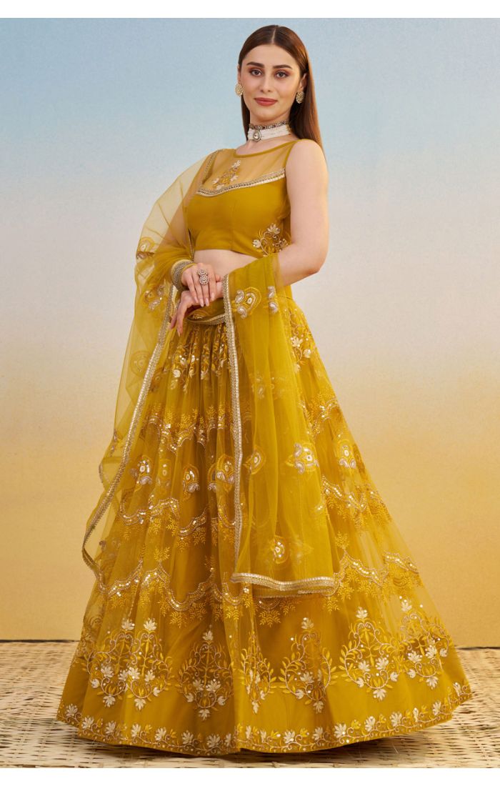 Flared skirt and border design of mustard yellow embroidered lehenga with intricate sequin and zari work, modern luxury ethnic wear.