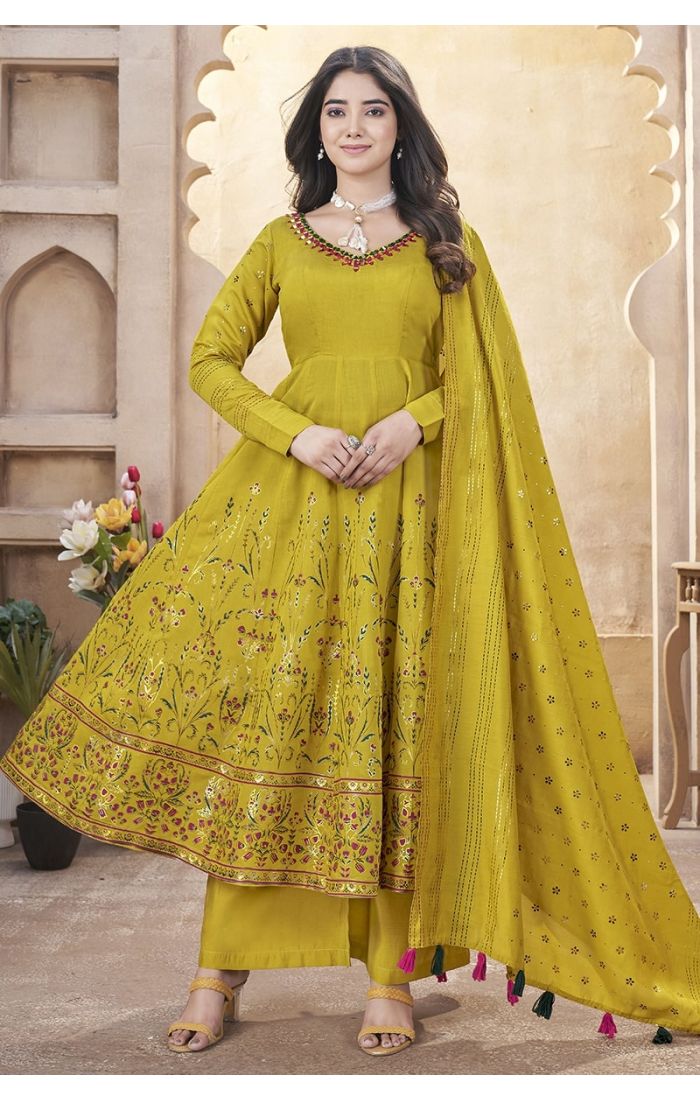 Mustard yellow embroidered palazzo suit with mirror work and tassel dupatta – perfect for weddings and festive occasions.