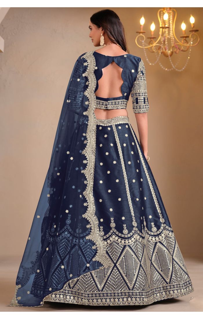 Model wearing navy blue art silk lehenga with mirror embroidery – full view