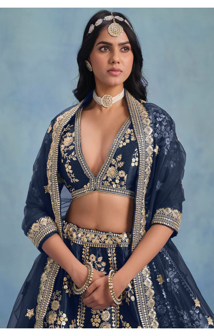 Close-up of navy blue embroidered lehenga choli with deep neckline