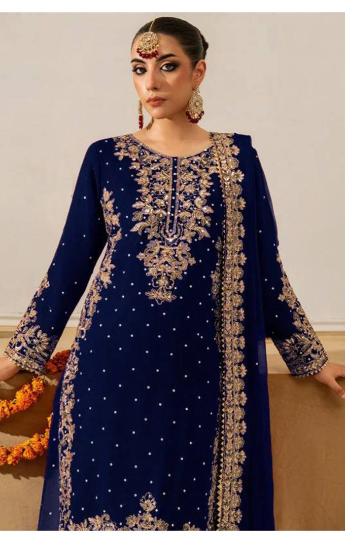 Close-up of navy blue salwar kameez round neck with intricate golden embroidery.