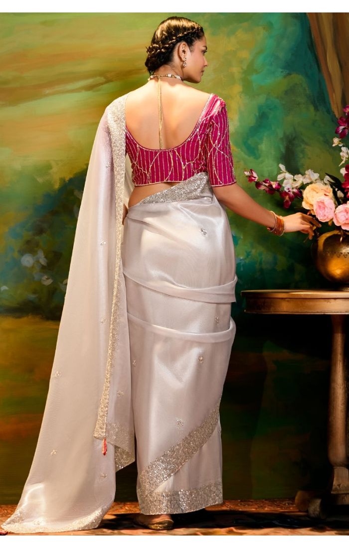Back view highlighting pink raw silk blouse and lace border